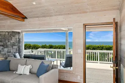 a living room with a couch and a balcony at Pacific Beach Oceanfront Compound with Casita in San Diego