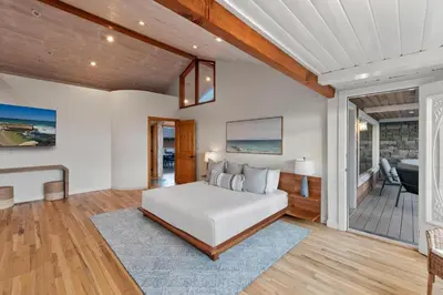 a bedroom with a bed and a living room at Pacific Beach Oceanfront Compound with Casita in San Diego
