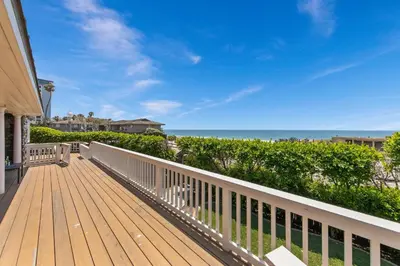 a wooden deck with a view of the beach at Pacific Beach Oceanfront Compound with Casita in San Diego