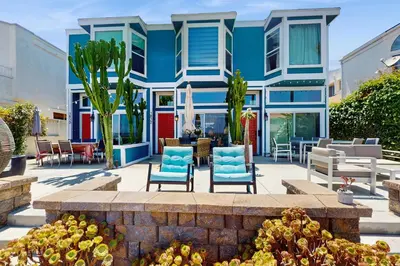 a blue house with blue chairs and a patio at Bayview Serenity Oceanfront in San Diego