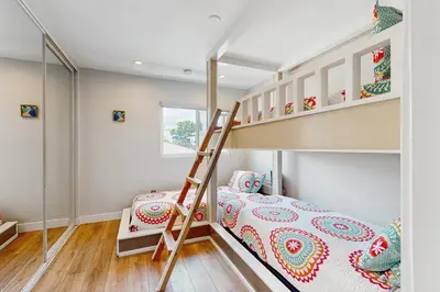 a kids room with a bunk bed and a staircase at Bayview Serenity Oceanfront in San Diego