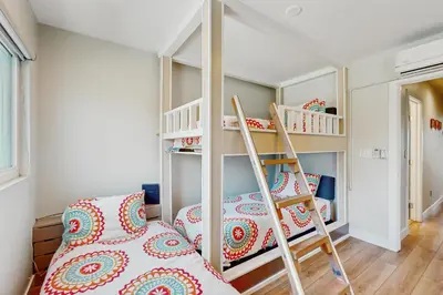 a room with a bunk bed and a ladder at Bayview Serenity Oceanfront in San Diego