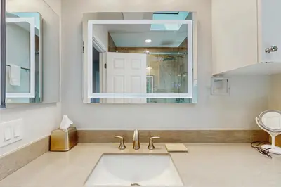 a bathroom with a sink and a mirror at Bayview Serenity Oceanfront in San Diego