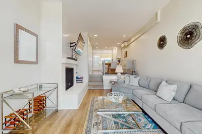 a living room with a couch and a table at Bayview Serenity Oceanfront in San Diego
