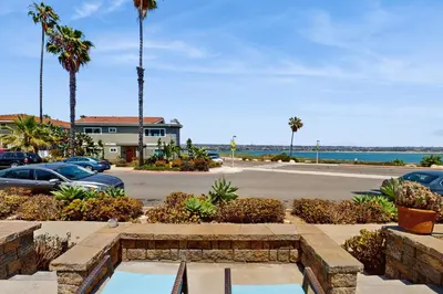 a view of a parking lot with palm trees and a street at Bayview Serenity Oceanfront in San Diego