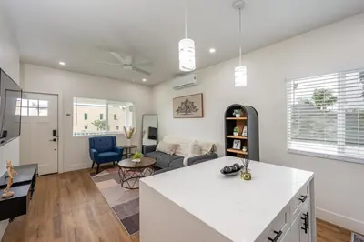 a kitchen and living room with a couch and a table at Modern home near Downtown San Diego in San Diego