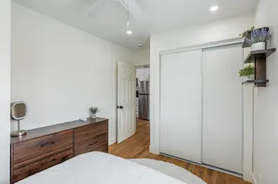 a bedroom with a sliding door leading to a kitchen at Modern home near Downtown San Diego in San Diego