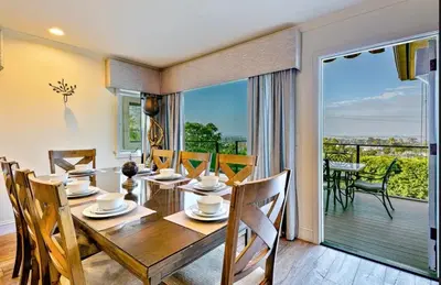 a dining room with a table and chairs and a balcony at Spacious 5BD Ocean Views Pool Jacuzzi in San Diego
