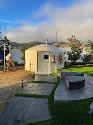 a large white dome house with a patio at Oasis Resort in Homeland