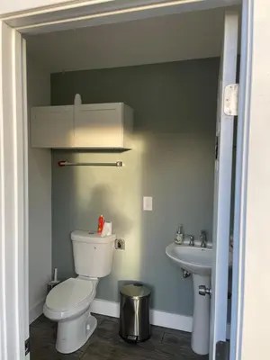 a bathroom with a toilet and a sink at Oasis Resort in Homeland