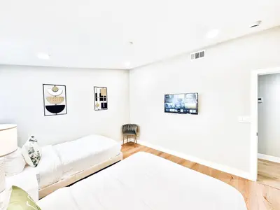 a bedroom with white walls and two beds at Xlnc Exotic home Poway in Poway