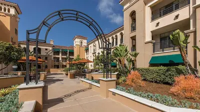 a walkway in front of a building with an arch at Marriott's Newport Coast 2BR Apartment with Resort Access in Newport Beach