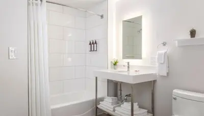 a white bathroom with a sink and a tub at Marriott's Newport Coast 2BR Apartment with Resort Access in Newport Beach