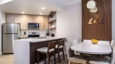 a kitchen with a table and a white counter top at Marriott's Newport Coast 2BR Apartment with Resort Access in Newport Beach