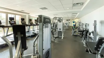 a gym with rows of treadmills and machines at Marriott's Newport Coast 2BR Apartment with Resort Access in Newport Beach