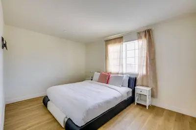 a bedroom with a bed with white sheets and a window at Nice and Comfortable for family in San Diego