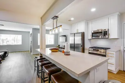 a kitchen with a large island with bar chairs at Nice and Comfortable for family in San Diego