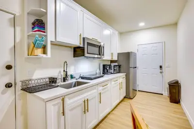 a kitchen with white cabinets and a stainless steel refrigerator at Nice and Comfortable for family in San Diego