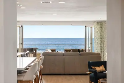 a living room with a couch and a view of the ocean at The Penthouse Oceanfront in Oceanside