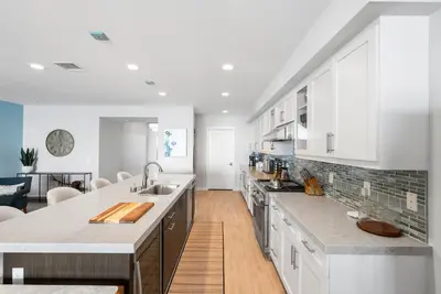 a kitchen with white cabinets and a counter top at The Penthouse Oceanfront in Oceanside