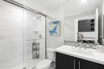 a bathroom with a sink and a shower and a toilet at The Penthouse Oceanfront in Oceanside
