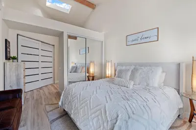 a white bedroom with a large bed and a window at Carlsbad Retreat by the Sea -30-Night Minimum in Carlsbad