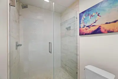 a shower with a glass door in a bathroom at Carlsbad Retreat by the Sea -30-Night Minimum in Carlsbad