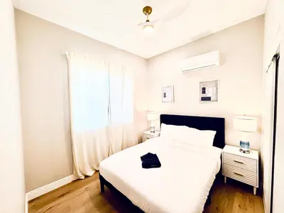 a white bedroom with a white bed and a window at Escondido Back Unit by sdstay in Escondido