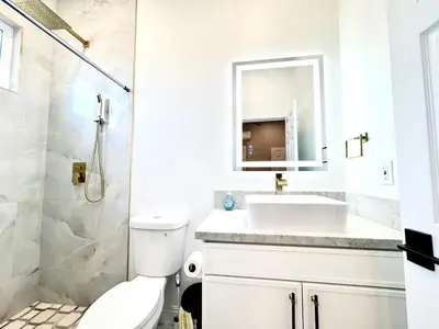a white bathroom with a sink and a mirror at Escondido Back Unit by sdstay in Escondido