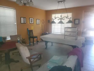 a living room with a bed and a table and chairs at Galaxy House in Sun City