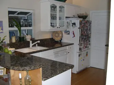 a kitchen with a sink and a refrigerator at Classic Laguna Cottage in Laguna Beach