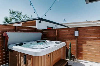 a hot tub sitting on the side of a fence at Chic Casita w BBQ, Patio, Backyard - 4 min to SDSU, 15 mins to beach, Unit B in La Mesa