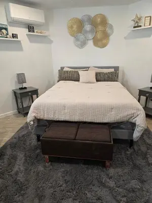 a bedroom with a bed and two tables with lamps at Cozy IBR with Bathtub Hot Tub, Near Golf, Beach, TJ in Bonita