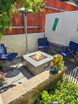 a patio with two chairs and a fire pit at Cozy IBR with Bathtub Hot Tub, Near Golf, Beach, TJ in Bonita