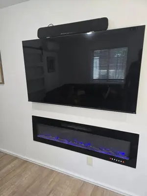 a large flat screen tv hanging on a wall at Cozy IBR with Bathtub Hot Tub, Near Golf, Beach, TJ in Bonita