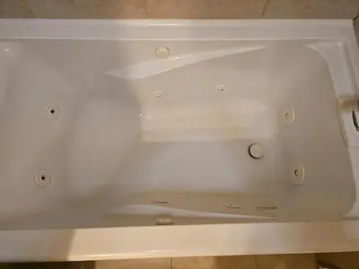a white bath tub sitting on top of a floor at Cozy IBR with Bathtub Hot Tub, Near Golf, Beach, TJ in Bonita
