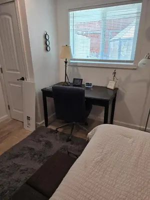 a bedroom with a desk with a chair and a bed at Cozy IBR with Bathtub Hot Tub, Near Golf, Beach, TJ in Bonita