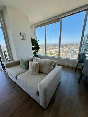 a couch in a living room with large windows at The Daisy-Highrise 2BR Marina View,Pool,Jacuzzi,Gym&Parking in San Diego