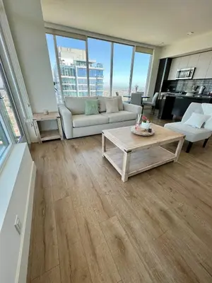 a living room with a couch and a coffee table at The Daisy-Highrise 2BR Marina View,Pool,Jacuzzi,Gym&Parking in San Diego