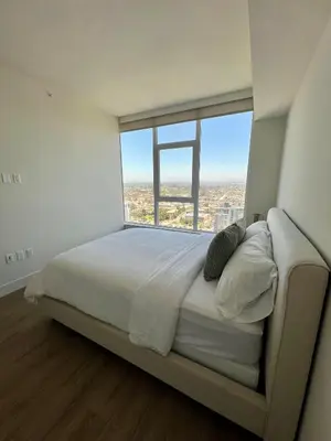 a large bed in a room with a large window at The Daisy-Highrise 2BR Marina View,Pool,Jacuzzi,Gym&Parking in San Diego