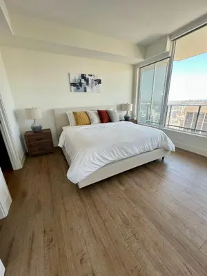 a bedroom with a large bed and a large window at The Daisy-Highrise 2BR Marina View,Pool,Jacuzzi,Gym&Parking in San Diego