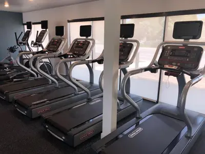 a row of cardio machines in a gym at The Daisy-Highrise 2BR Marina View,Pool,Jacuzzi,Gym&Parking in San Diego