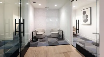 a waiting room with two chairs and a table at Global Luxury Suites Mission Valley in San Diego