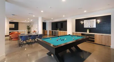 a billiard room with a pool table and a bar at Global Luxury Suites Mission Valley in San Diego