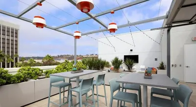 a patio with two tables and chairs in a building at Global Luxury Suites Mission Valley in San Diego