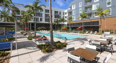 an outdoor pool at a resort with tables and chairs at Global Luxury Suites Mission Valley in San Diego
