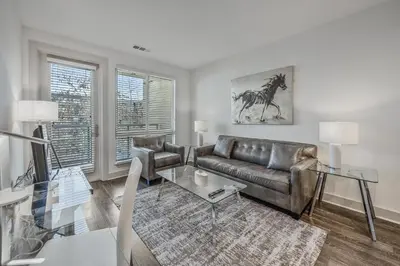 a living room with a leather couch and a table at Global Luxury Suites Mission Valley East in San Diego