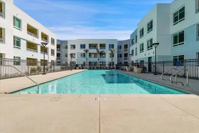a swimming pool in the courtyard of a apartment building at Global Luxury Suites near Liberty Station in San Diego