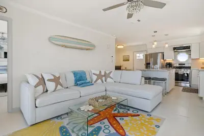 a living room with a couch and a table at Luxury Oceanfront steps to Beach & Town, Best views! in Oceanside