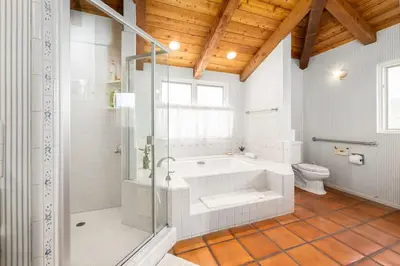 a bathroom with a tub and a toilet at 4 Bedroom With Pool in Oceanside